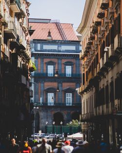 People on street amidst buildings in city