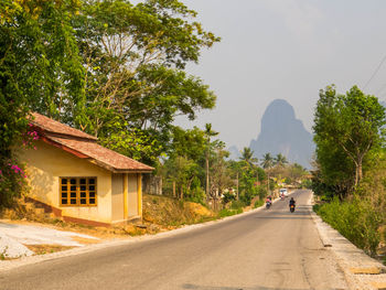 Rear view of man walking on road