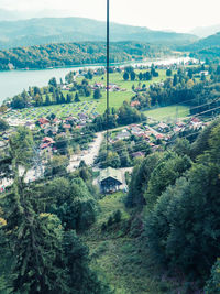High angle view of houses by sea against sky