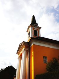 Low angle view of bell tower against sky