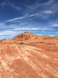 Scenic view of desert against blue sky