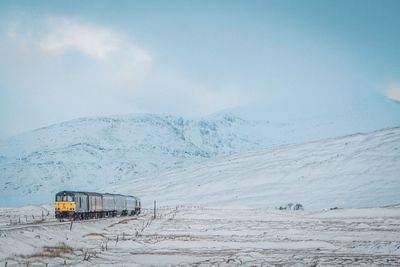 Train against snowcapped mountains during winter
