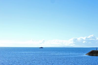 Scenic view of sea against blue sky