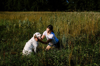 Girl with dog on field