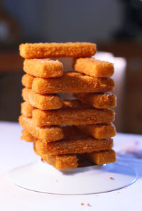 Fried fish stacked on table