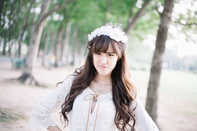 Portrait of a young woman standing outdoors