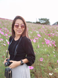 Portrait of smiling woman standing on field