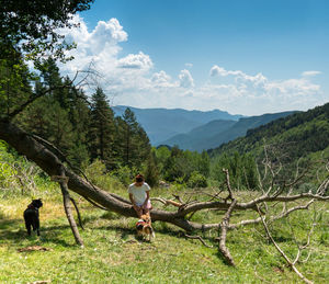 Full length of man climbing on mountain against sky