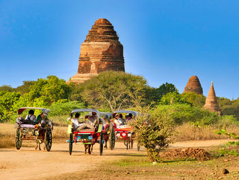 Group of people in front of temple against clear sky