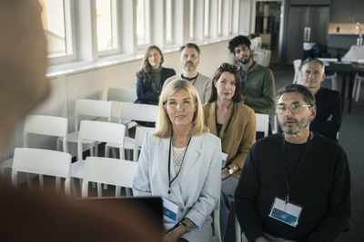 Group of business people attending presentation during conference