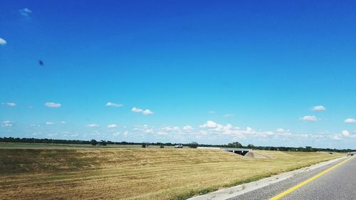 Scenic view of agricultural field against clear blue sky