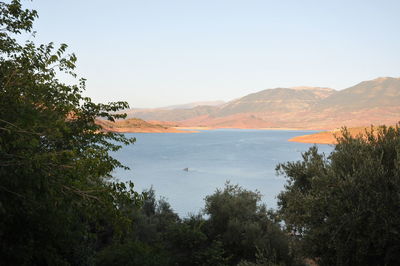 Scenic view of sea and mountains against sky