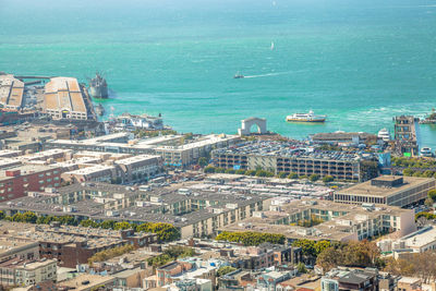 High angle view of cityscape by sea against sky