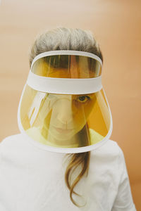 Woman staring through yellow transparent sun visor