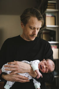 Father holding crying baby