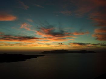 Scenic view of sea against dramatic sky during sunset