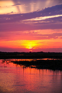 Scenic view of lake at sunset