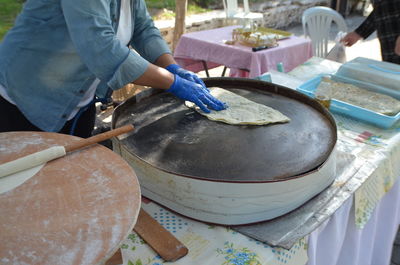 Midsection of man preparing food on table