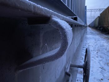 Close-up of wet metal railing during winter