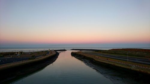 Scenic view of sea against clear sky at sunset