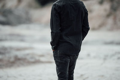 Rear view of a man walking on beach