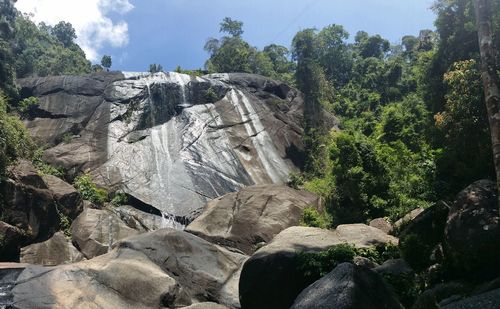 Scenic view of waterfall against sky