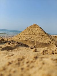 Sand pyramid structure on seashore 