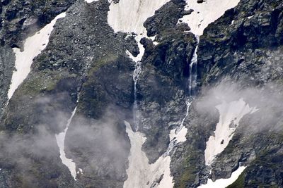 Scenic view of rocks with snow and waterfalls