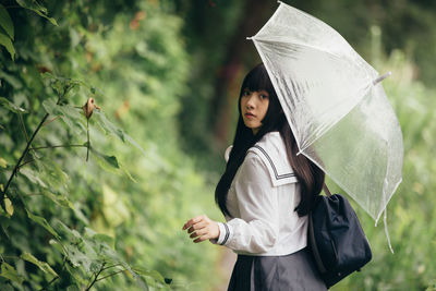 Full length of woman standing on rainy day