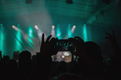 People photographing at music concert