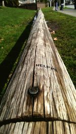 Close-up of wooden fence on grassy field
