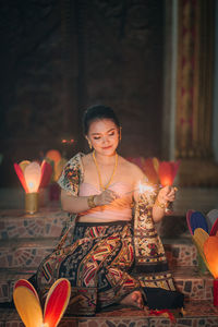 A girl with lighting firework on buddhist lent day