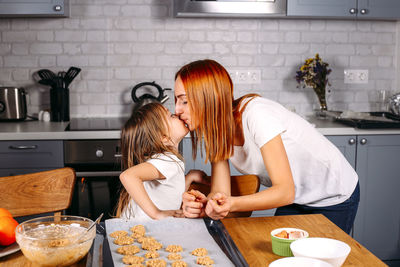 Midsection of woman having food at home