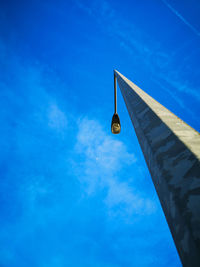 Low angle view of street light against blue sky