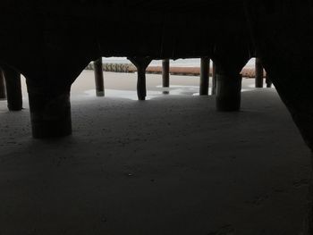 Silhouette of pier on beach