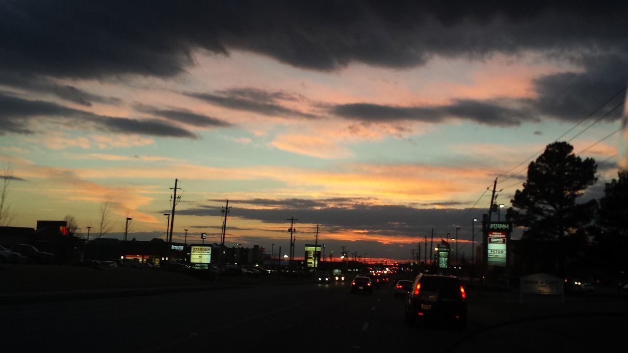 transportation, car, land vehicle, sunset, road, mode of transport, sky, street, cloud - sky, road marking, traffic, on the move, street light, the way forward, silhouette, illuminated, orange color, city, dusk, travel