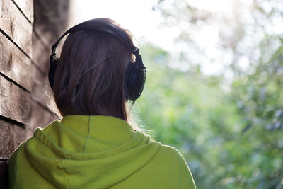 Rear view of woman wearing headphones