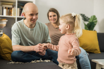 Happy family sitting on sofa at home