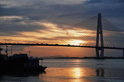 Silhouette of suspension bridge at sunset