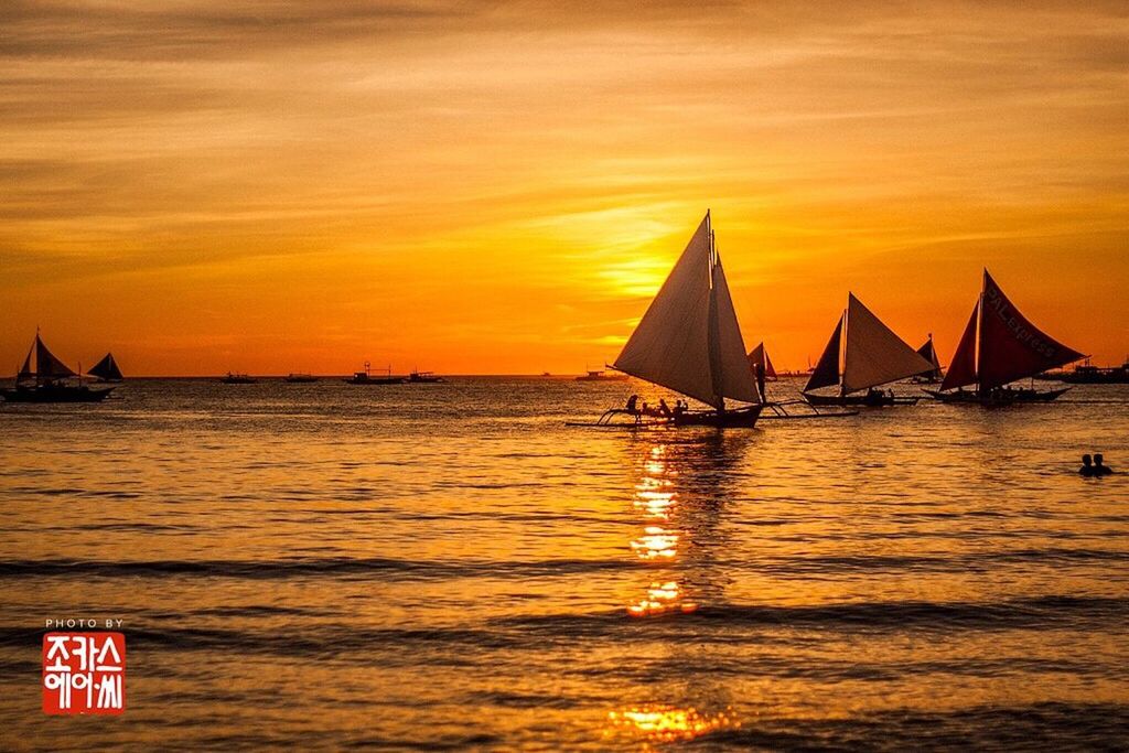 water, sea, sunset, transportation, scenics, nautical vessel, sky, horizon over water, tranquil scene, tranquility, boat, waterfront, orange color, beauty in nature, nature, idyllic, rippled, mode of transport, sailboat, flag