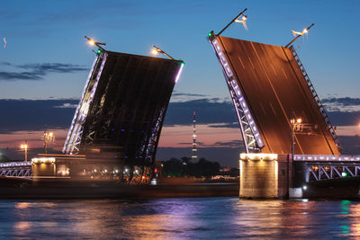 Bascule bridge over river at sunset