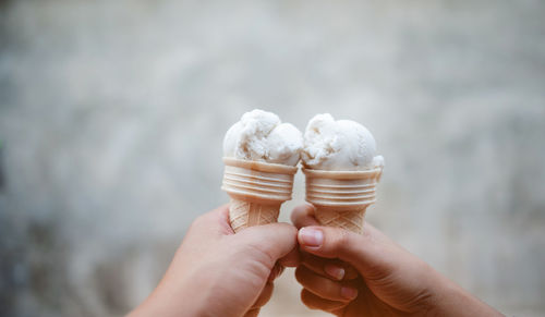 Cropped hand of person holding ice cream cone