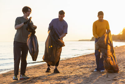 Rear view of couple standing at beach