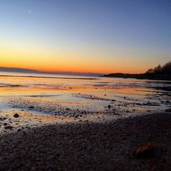 Scenic view of beach against sky during sunset