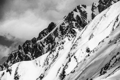 Low angle view of snowcapped mountain against sky