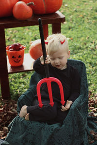 Full length of boy sitting in traditional clothing