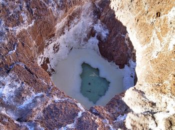 High angle view of rocks in water during winter