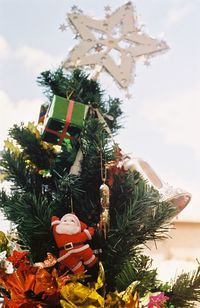 Low angle view of christmas tree against sky