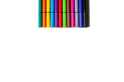 Close-up of multi colored pencils over white background