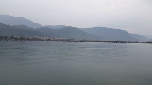 Scenic view of lake and mountains against sky